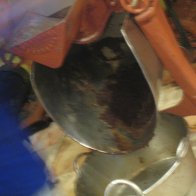 Chocolate falling onto sugar in Mayordomo grinder