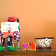 A fairy relaxes beside a cocoa bowl