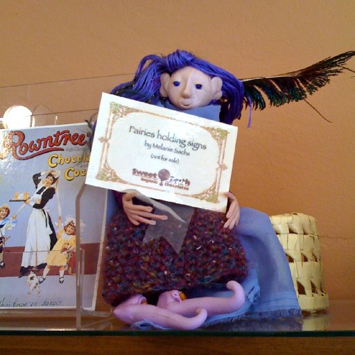 Mildred May holds an explanatory sign