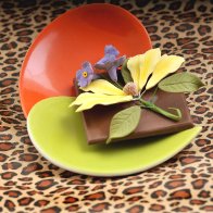 Gumpaste orchid on chocolate square.
